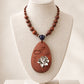 Silver Lotus Bloom Oval Rosewood Pendant Necklace with Carved Leaf Detail *
